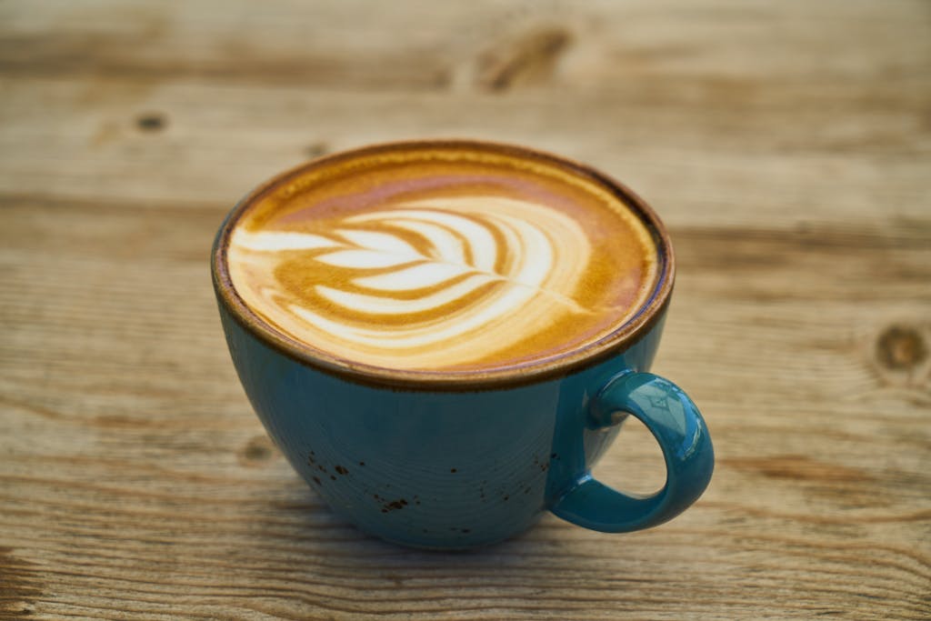 Close-Up Photo of Coffee on Teal Ceramic Cup